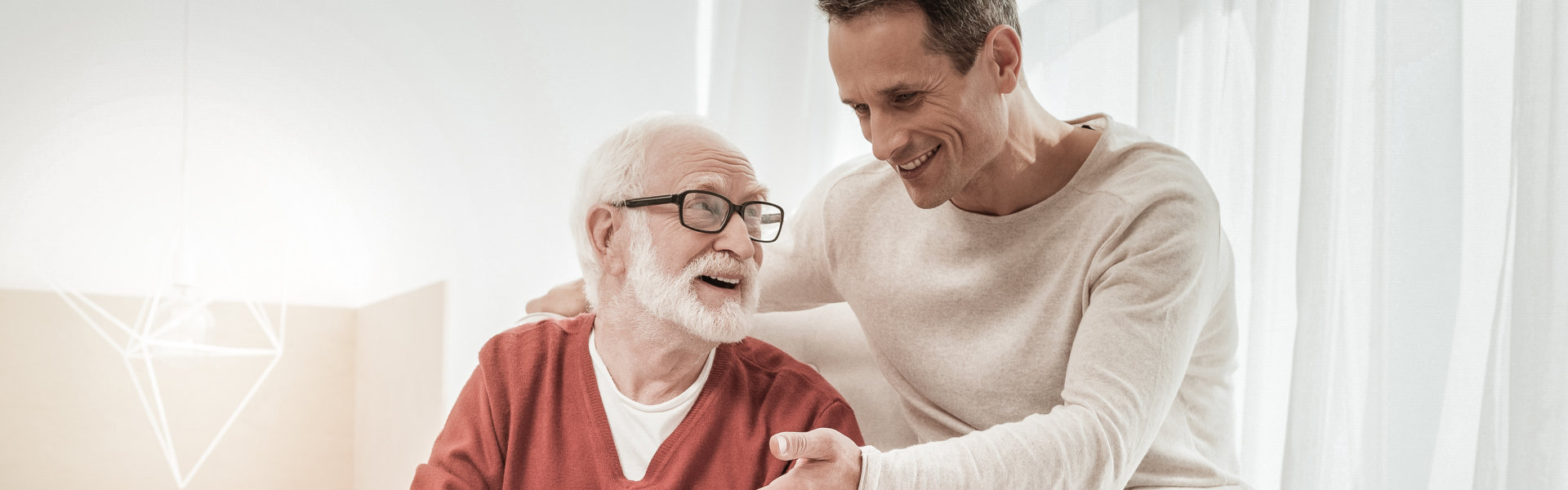 elderly patient and a man smiling