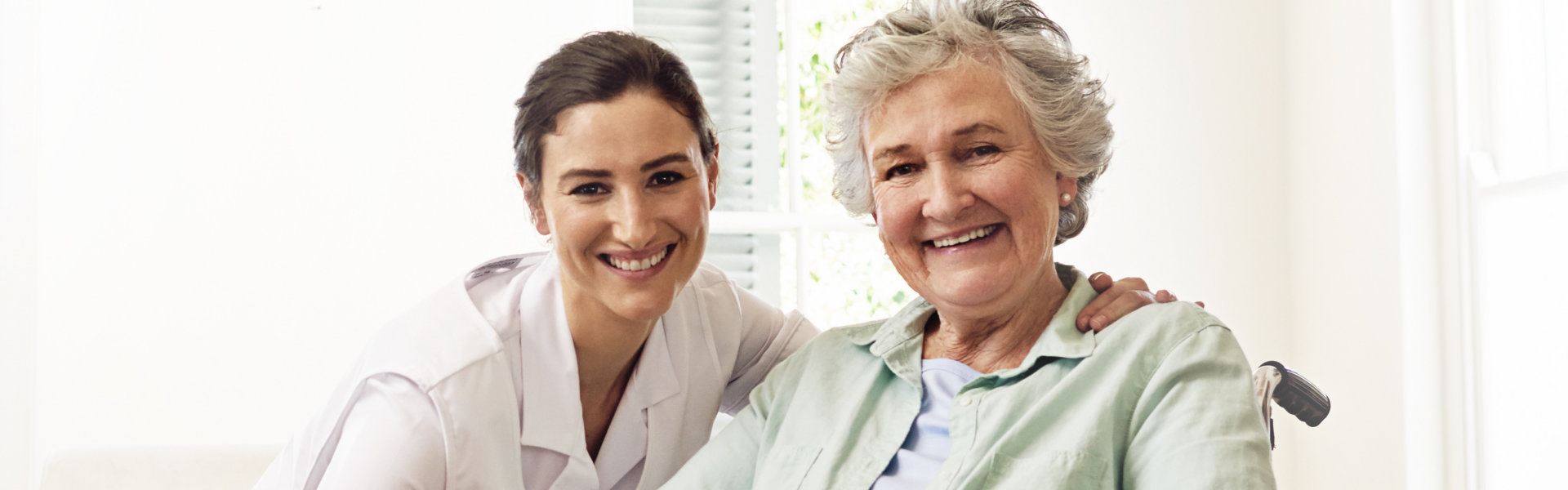 caregiver and her patient smile on the camera