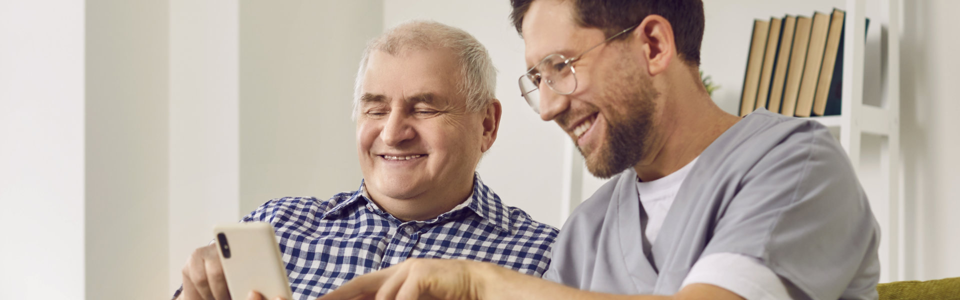 caregiver assist his patient in using phone