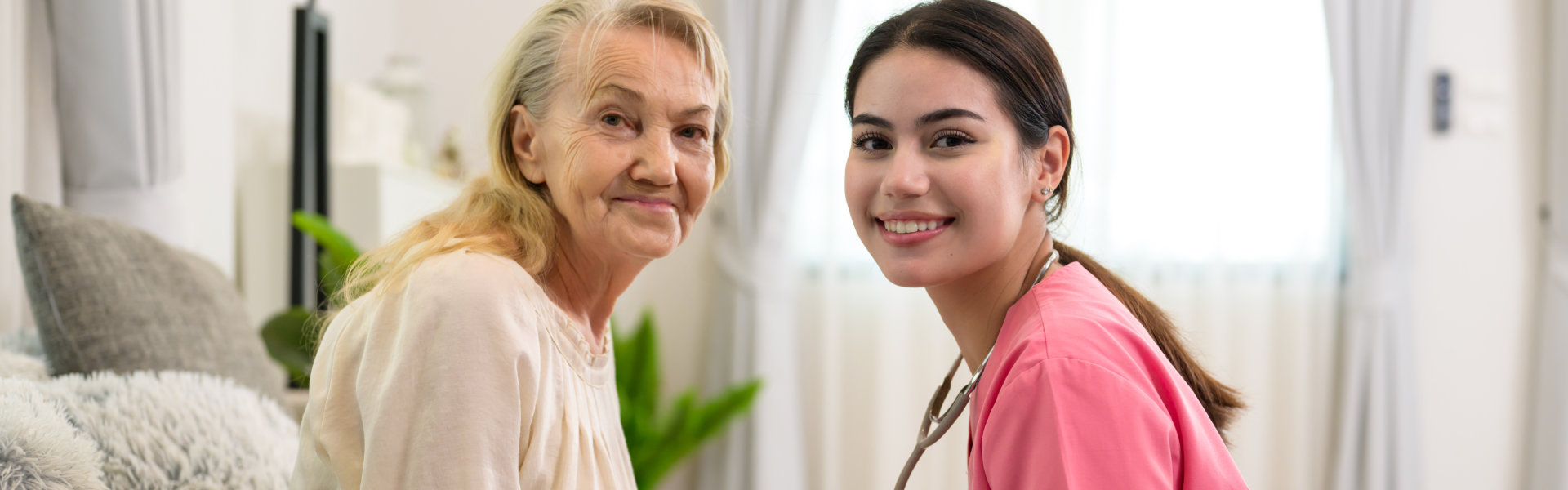 caregiver and her patient smile on the camera